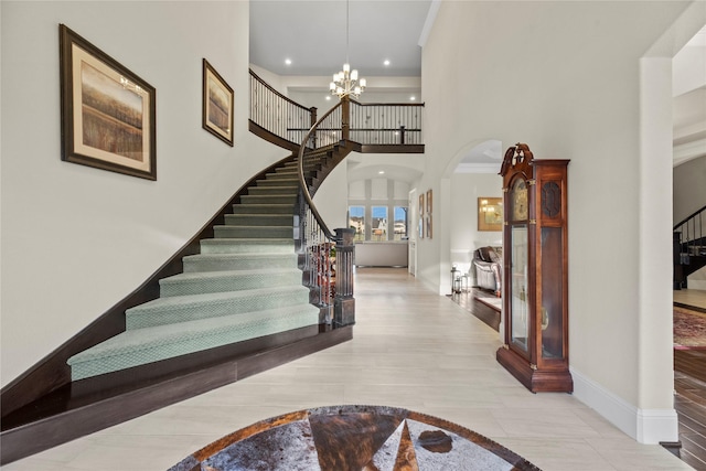 2410 Legends Way, Katy, TX 77493 - entryway featuring arched walkways, a high ceiling, stairway, baseboards, and a chandelier