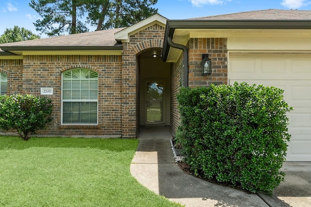 27017 Del Rio Trl W, Magnolia, TX 77355 - doorway to property featuring a garage, a yard, brick siding, and roof with shingles