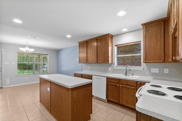 27017 Del Rio Trl W, Magnolia, TX 77355 - kitchen with white appliances, light tile patterned floors, a kitchen island, a sink, and brown cabinetry