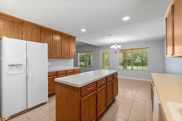 27017 Del Rio Trl W, Magnolia, TX 77355 - kitchen with white refrigerator with ice dispenser, light tile patterned flooring, brown cabinets, light countertops, and recessed lighting