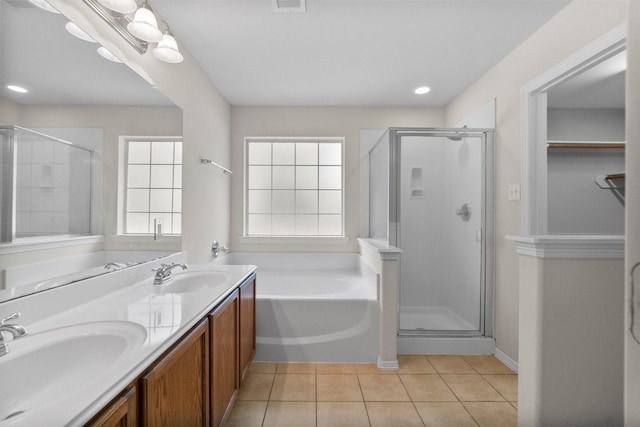 27017 Del Rio Trl W, Magnolia, TX 77355 - bathroom with a shower stall, a bath, tile patterned floors, double vanity, and recessed lighting