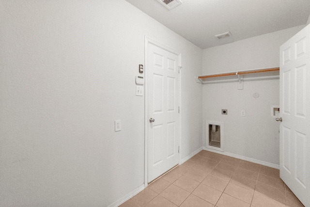 27017 Del Rio Trl W, Magnolia, TX 77355 - laundry room with hookup for an electric dryer, hookup for a gas dryer, light tile patterned floors, hookup for a washing machine, and baseboards