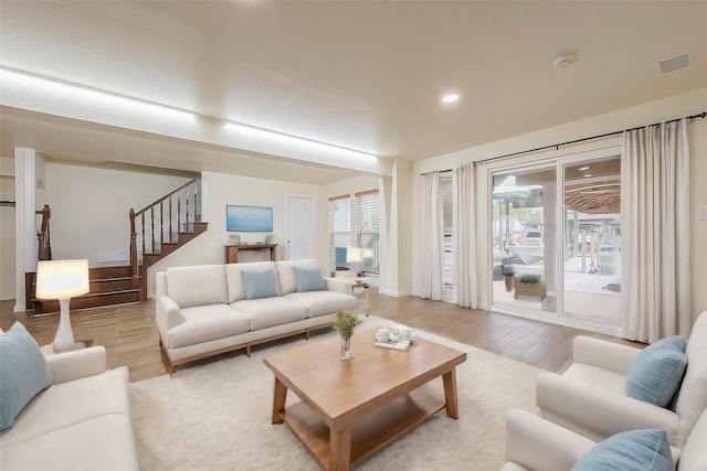 1407 Tiki Dr, Tiki Island, TX 77554 - living room featuring light wood-style floors, stairs, recessed lighting, and baseboards