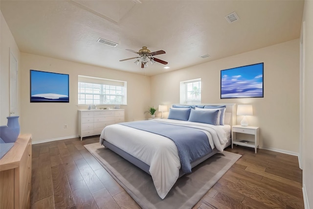 1407 Tiki Dr, Tiki Island, TX 77554 - bedroom featuring baseboards, multiple windows, dark wood finished floors, and a ceiling fan