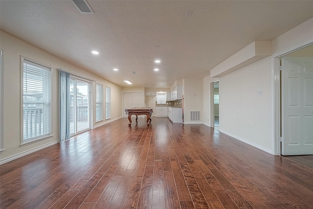 1407 Tiki Dr, Tiki Island, TX 77554 - unfurnished living room with dark wood-type flooring, recessed lighting, and baseboards