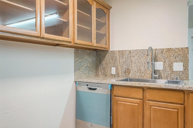 1407 Tiki Dr, Tiki Island, TX 77554 - kitchen featuring dishwasher, a sink, glass insert cabinets, backsplash, and light stone countertops