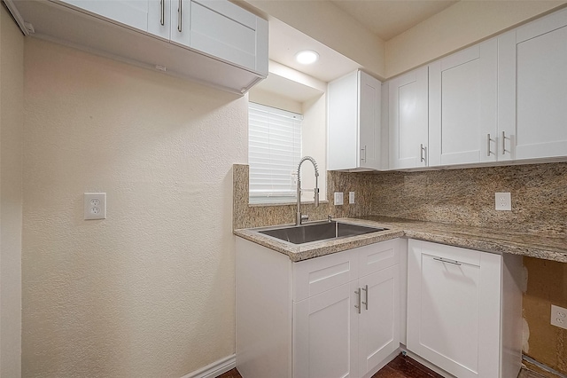 1407 Tiki Dr, Tiki Island, TX 77554 - kitchen with a sink, decorative backsplash, white cabinetry, and recessed lighting