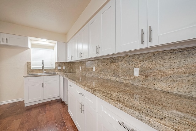 1407 Tiki Dr, Tiki Island, TX 77554 - kitchen with a sink, dark wood-style flooring, white cabinets, and backsplash