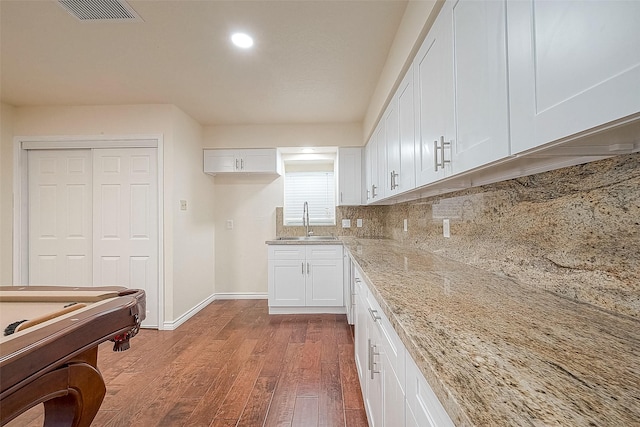 1407 Tiki Dr, Tiki Island, TX 77554 - kitchen with a sink, wood finished floors, baseboards, white cabinets, and recessed lighting