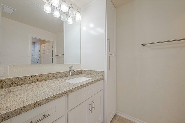 1407 Tiki Dr, Tiki Island, TX 77554 - bathroom featuring vanity, baseboards, and tile patterned flooring
