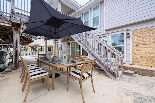 1407 Tiki Dr, Tiki Island, TX 77554 - view of patio / terrace with outdoor dining area and stairway