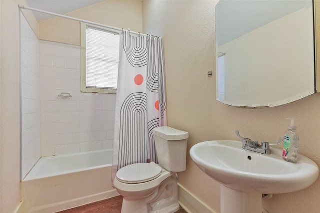 1809 31st St, Galveston, TX 77550 - bathroom featuring shower / tub combo, toilet, a textured wall, wood finished floors, and a sink