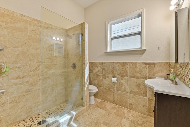 1809 31st St, Galveston, TX 77550 - bathroom with vanity, tile walls, a tile shower, toilet, and wainscoting