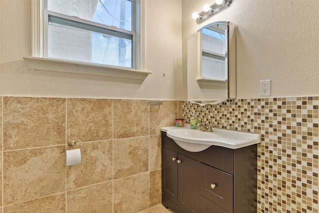 1809 31st St, Galveston, TX 77550 - bathroom featuring vanity, tile walls, and a textured wall