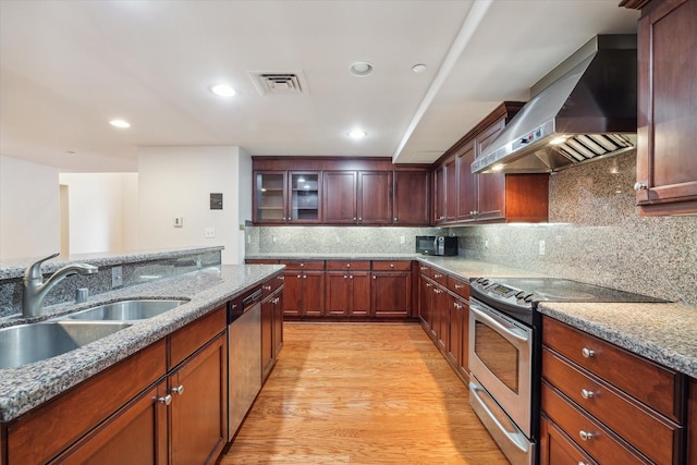 914 Main St Unit 1104, Houston, TX 77002 - kitchen with range hood, appliances with stainless steel finishes, a sink, light stone countertops, and recessed lighting