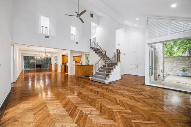 4 River Hollow Ln, Houston, TX 77027 - foyer with a high ceiling, a ceiling fan, a chandelier, stairway, and baseboards