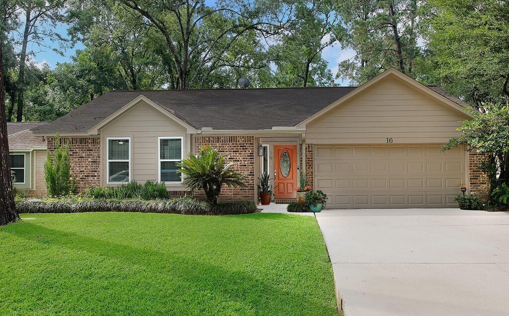 16 W Lance Leaf Rd, The Woodlands, TX 77381 - single story home featuring brick siding, a garage, concrete driveway, a front yard, and a shingled roof