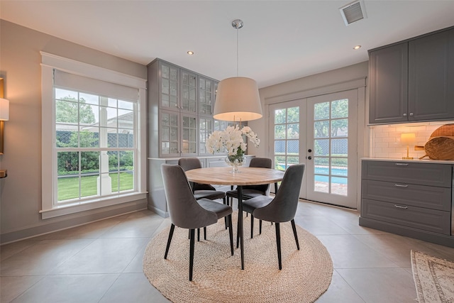 14827 River Forest Dr, Houston, TX 77079 - dining area with light tile patterned floors, french doors, baseboards, and recessed lighting