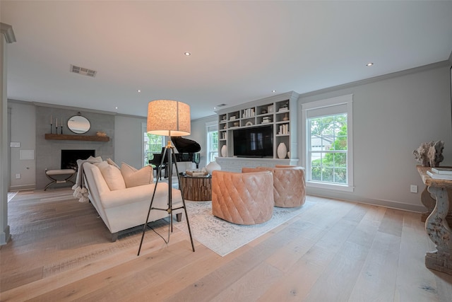 14827 River Forest Dr, Houston, TX 77079 - living room with a large fireplace, ornamental molding, light wood-type flooring, healthy amount of natural light, and recessed lighting