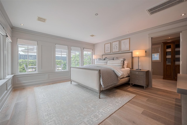 14827 River Forest Dr, Houston, TX 77079 - bedroom featuring crown molding, light wood finished floors, and a decorative wall