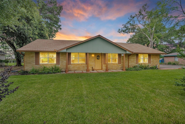 511 Northwood Dr, Conroe, TX 77303 - ranch-style home with a lawn, brick siding, and covered porch
