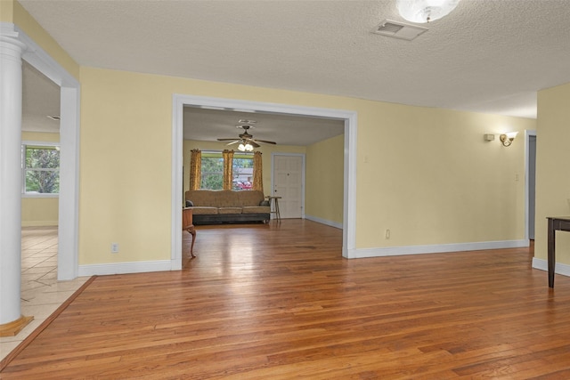 511 Northwood Dr, Conroe, TX 77303 - unfurnished room with light wood-type flooring, baseboards, ceiling fan, and a textured ceiling