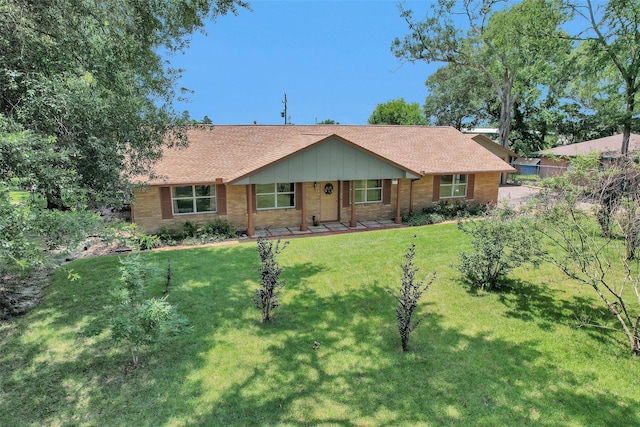 511 Northwood Dr, Conroe, TX 77303 - ranch-style house featuring roof with shingles and brick siding