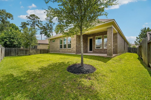 103 Catesby Ct, Conroe, TX 77304 - rear view of house with brick siding and a patio area