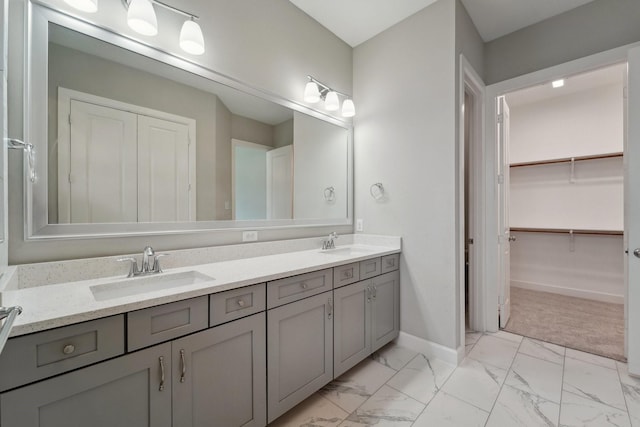 103 Catesby Ct, Conroe, TX 77304 - bathroom with double vanity, marble look tiles, baseboards, and a walk in closet
