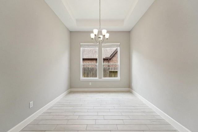 103 Catesby Ct, Conroe, TX 77304 - unfurnished room with a chandelier, a raised ceiling, and baseboards