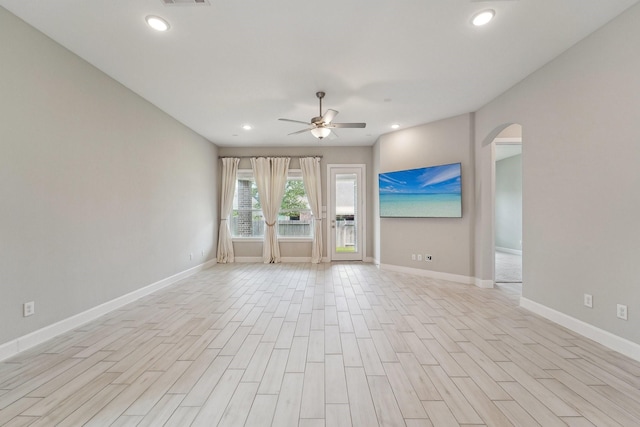 103 Catesby Ct, Conroe, TX 77304 - spare room with arched walkways, a ceiling fan, baseboards, light wood-type flooring, and recessed lighting