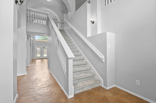18222 Winding Timbers Ln, Humble, TX 77346 - stairway featuring a high ceiling, french doors, baseboards, and carpet