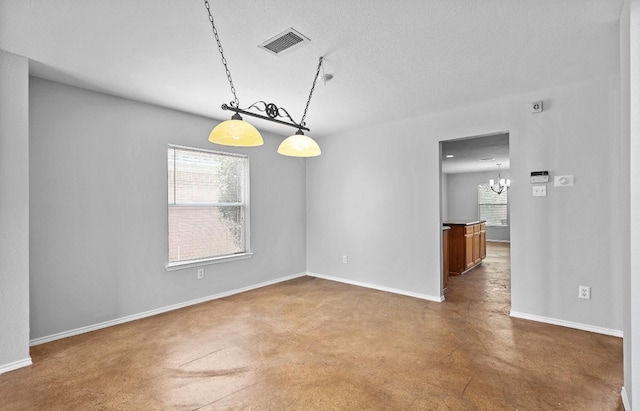 18222 Winding Timbers Ln, Humble, TX 77346 - spare room with finished concrete floors, a chandelier, baseboards, and a textured ceiling