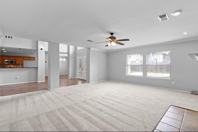18222 Winding Timbers Ln, Humble, TX 77346 - unfurnished living room featuring carpet floors, a ceiling fan, baseboards, recessed lighting, and a chandelier
