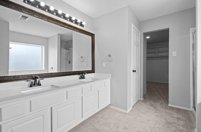18222 Winding Timbers Ln, Humble, TX 77346 - bathroom with a stall shower, double vanity, baseboards, and a spacious closet