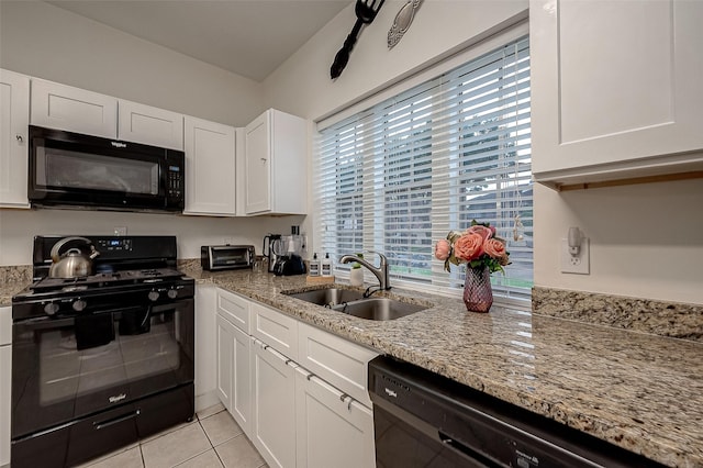 8719 Rose Garden Dr, Houston, TX 77083 - kitchen with black appliances, a sink, white cabinetry, light tile patterned floors, and light stone counters