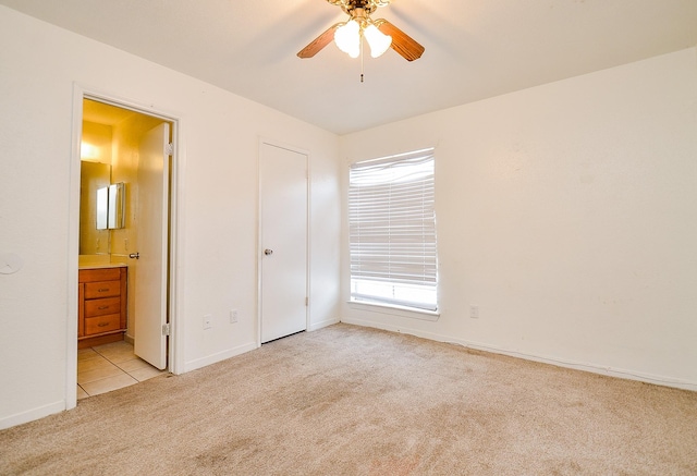 9350 Country Creek Dr Unit 5, Houston, TX 77036 - unfurnished bedroom featuring light colored carpet, connected bathroom, and baseboards