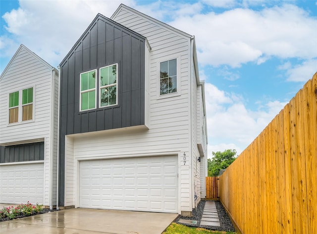 407 Sikes St, Houston, TX 77018 - view of front of home with board and batten siding, an attached garage, and driveway
