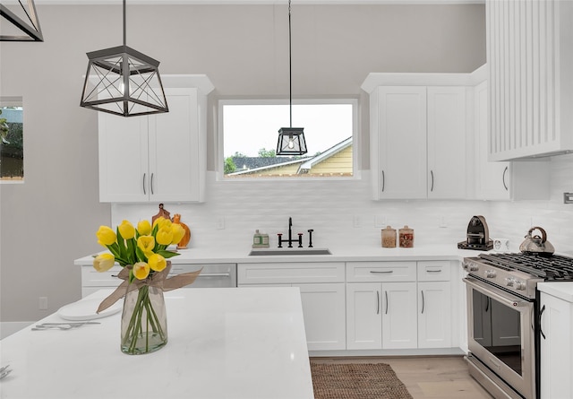 407 Sikes St, Houston, TX 77018 - kitchen featuring appliances with stainless steel finishes, light countertops, tasteful backsplash, and white cabinets