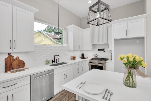 407 Sikes St, Houston, TX 77018 - kitchen featuring stainless steel appliances, tasteful backsplash, white cabinetry, light countertops, and hanging light fixtures
