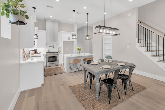 407 Sikes St, Houston, TX 77018 - dining space with light wood-style flooring, stairway, and recessed lighting