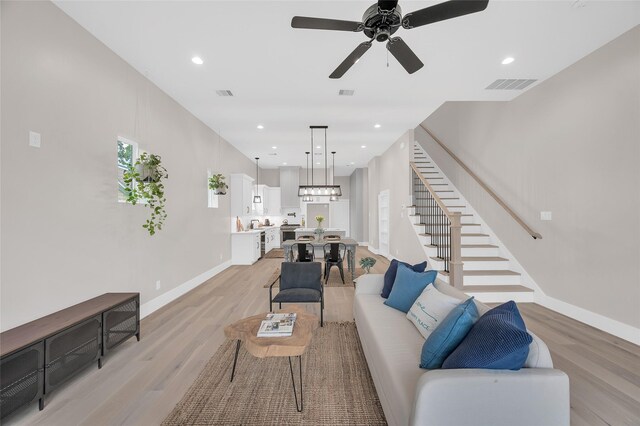 407 Sikes St, Houston, TX 77018 - living area featuring light wood-type flooring, stairs, baseboards, a ceiling fan, and recessed lighting
