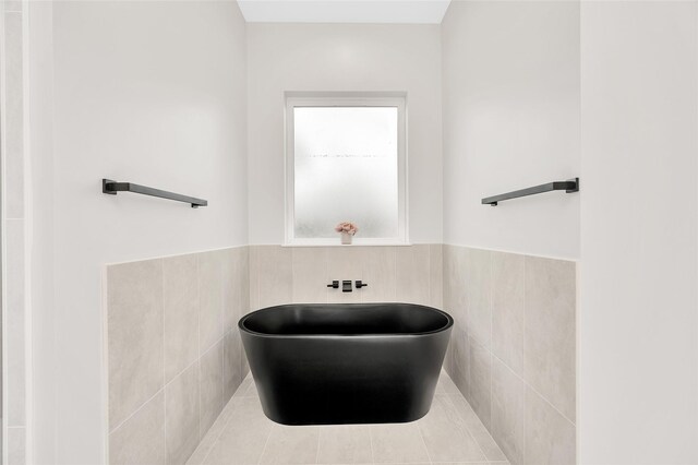 407 Sikes St, Houston, TX 77018 - full bathroom with a freestanding bath, tile walls, and a wainscoted wall