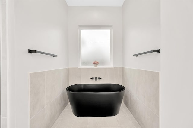 407 Sikes St, Houston, TX 77018 - full bathroom featuring a freestanding tub, tile walls, and a wainscoted wall