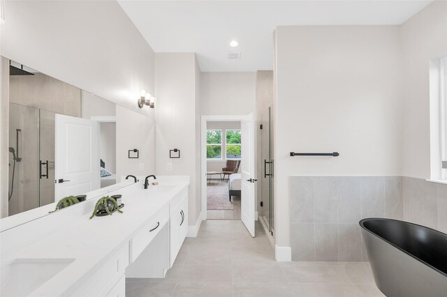 407 Sikes St, Houston, TX 77018 - bathroom featuring a shower stall, double vanity, a freestanding tub, and connected bathroom