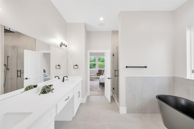 407 Sikes St, Houston, TX 77018 - ensuite bathroom featuring a stall shower, double vanity, a freestanding tub, and tile patterned flooring