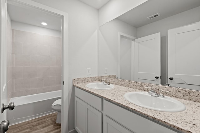 32923 Turning Springs Dr, Fulshear, TX 77423 - bathroom with toilet, double vanity, wood finished floors, and shower / washtub combination
