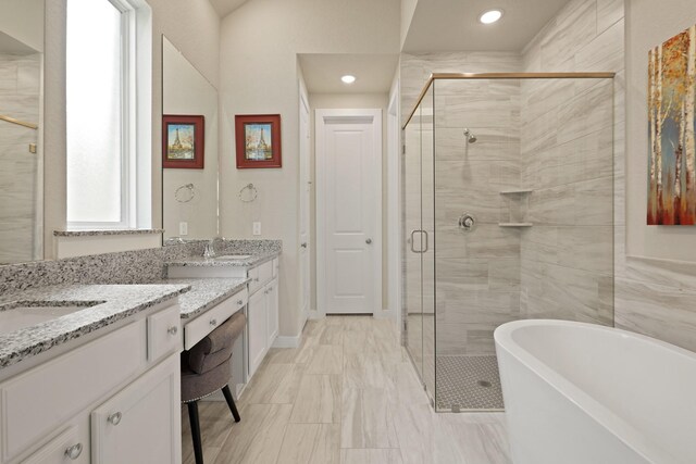 5118 Pomegranate Path, Manvel, TX 77578 - full bathroom featuring two vanities, a stall shower, a freestanding tub, recessed lighting, and marble finish floors