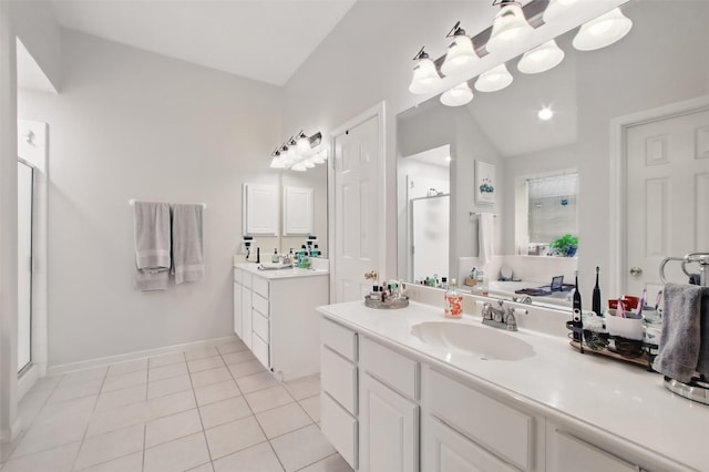 30915 Caraquet Ct, Spring, TX 77386 - full bath featuring a stall shower, two vanities, tile patterned floors, and vaulted ceiling