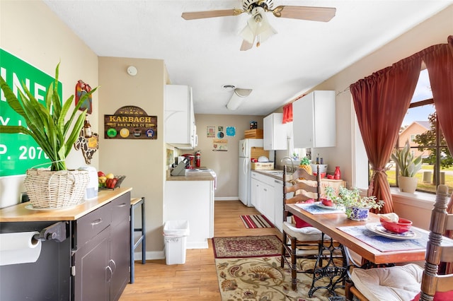 23718 E Webb Rd, Porter, TX 77365 - dining room with light wood-style flooring, ceiling fan, and baseboards